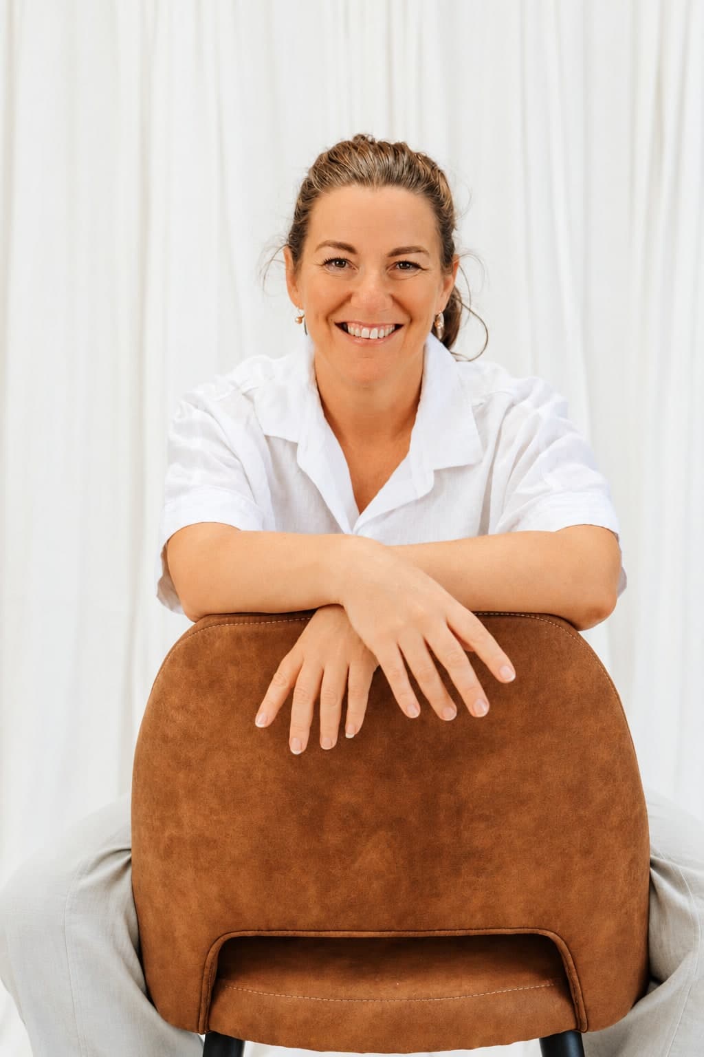 Kathryn Weekley, founder of CH Digitals, leaning on the back of a chair
